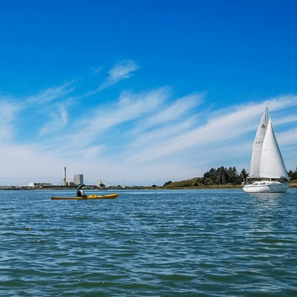 Kayak and sailboat in the water